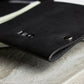 Black leather wallet on a concrete surface
