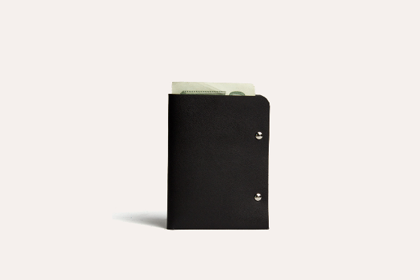 Black leather wallet with money on a white background