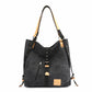 Black handbag with tan accents on a white background