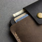 Close-up of a leather wallet with cards on a textured surface