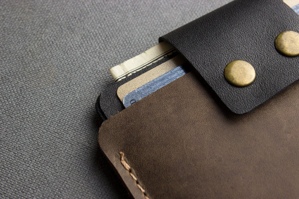 Close-up of a leather wallet with cards on a textured surface