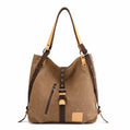 Brown shoulder bag with leather straps on a white background