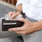Person holding a wallet with money, sitting on a couch.