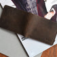 Brown leather wallet on a magazine with 'KIKO' branding