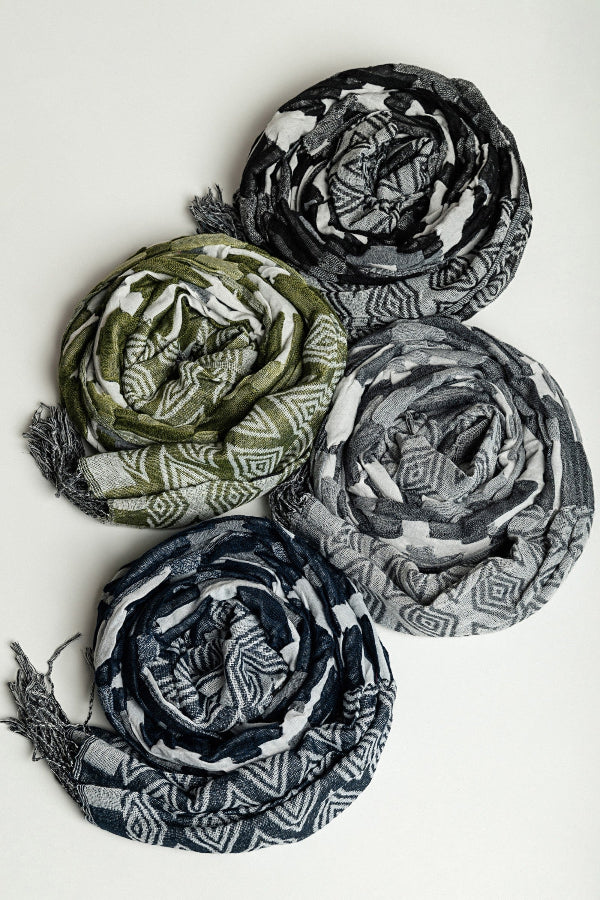 Four folded scarves in green, black, and gray on a white background