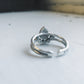 Silver ring on a light gray surface with a blurred background