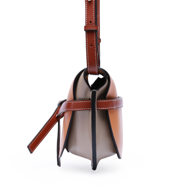 Two-tone handbag with brown and black straps on a white background