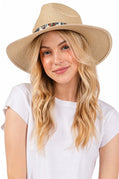 Woman wearing a beige straw hat with a white background