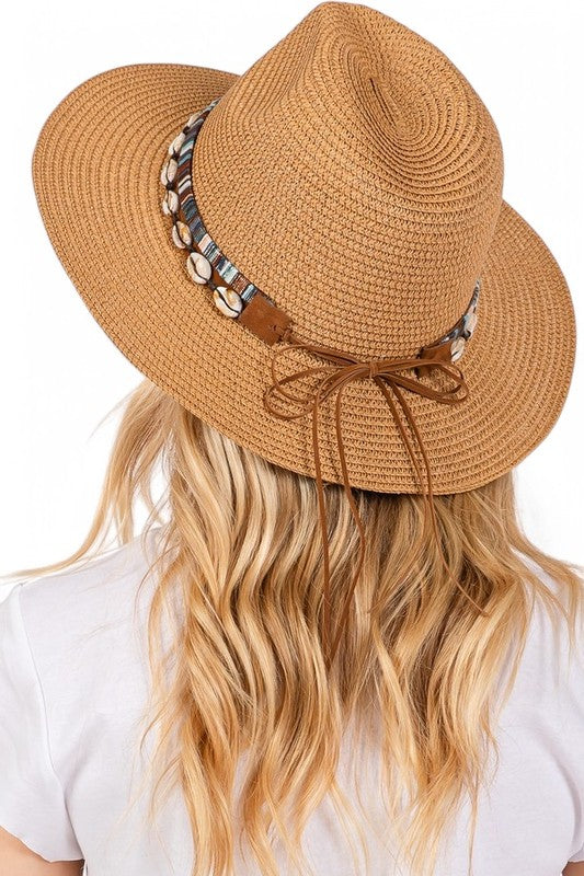 Brown straw hat with decorative band and bow on a white background