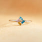 Ring with multicolored gemstones on a beige background