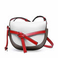 White handbag with red accents on a white background