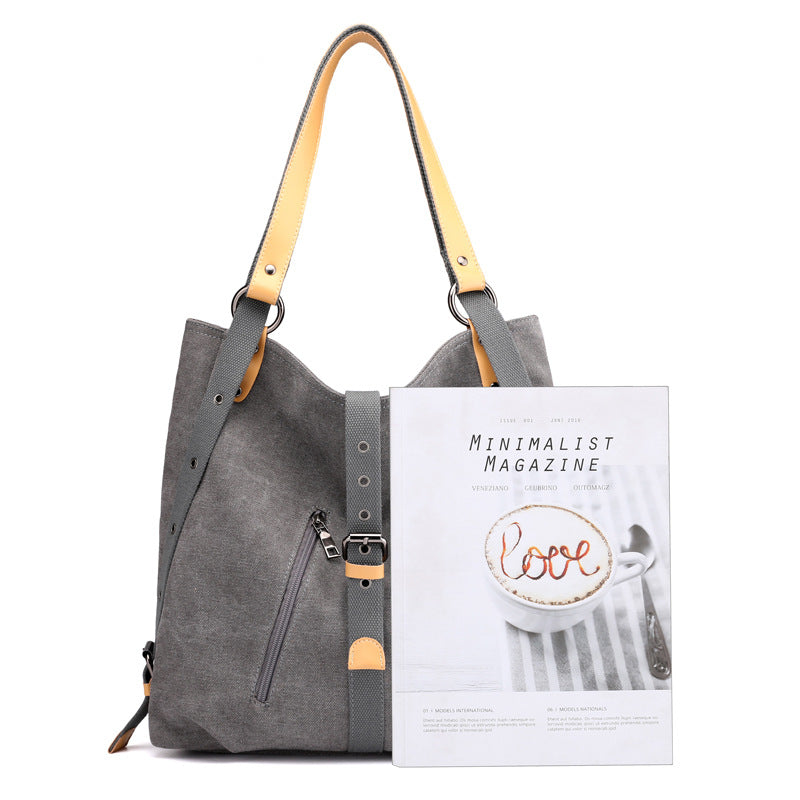 Gray handbag with yellow strap and 'Minimalist Magazine' on a white background