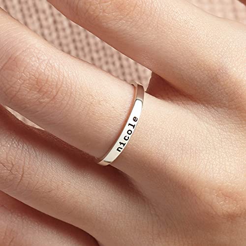 Silver ring with 'nicole' engraved on a finger