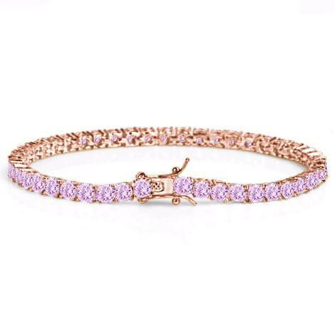 Rose gold bracelet with pink gemstones on a white background