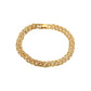 Gold bracelet with diamond accents on a white background