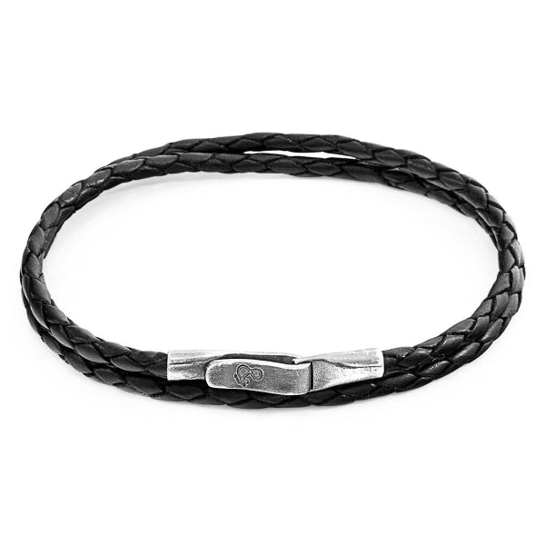 Black braided leather bracelet with a silver clasp on a white background