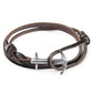 Brown leather bracelet with silver anchor charm on a white background