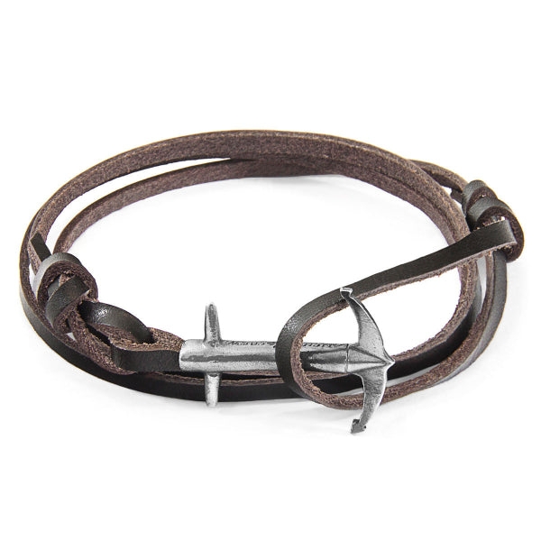 Brown leather bracelet with silver anchor charm on a white background