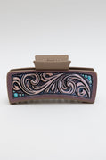 Decorative hair clip with intricate patterns on a white background