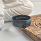 Black ring with 'Tungsten Carbide' engraving on a wooden surface