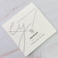 Necklace with a diamond pendant on a jewelry card with brand name 'ly'.