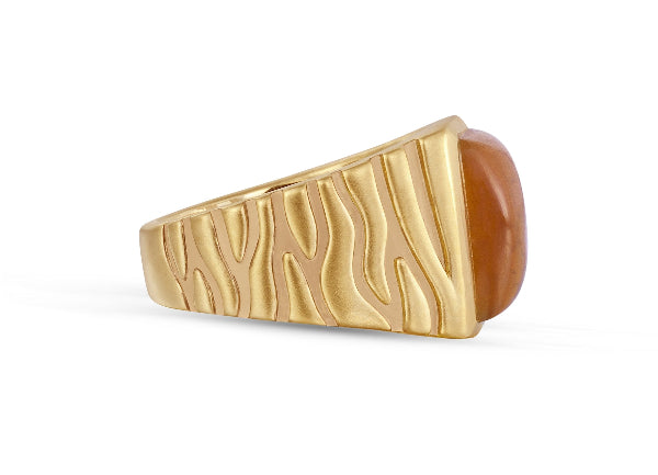 Gold ring with a brown stone on a white background