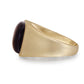 Gold ring with a dark gemstone on a white background