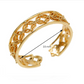 Gold bracelet with intricate design on a white background