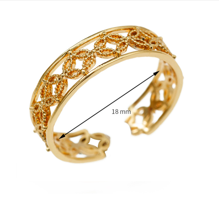 Gold bracelet with intricate design on a white background