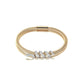 Gold bracelet with diamond accents on a white background