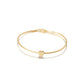 Gold bracelet with a heart charm on a white background