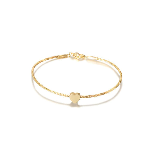 Gold bracelet with a heart charm on a white background