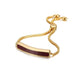 Gold bracelet with a red bar clasp on a white background