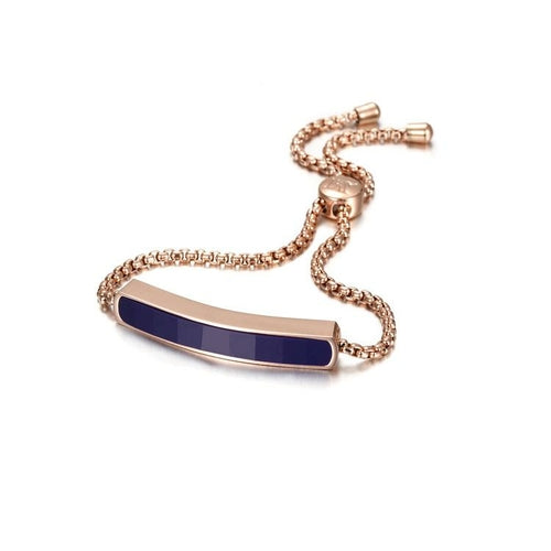 Rose gold bracelet with a blue bar on a white background