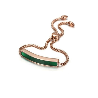 Rose gold bracelet with a green bar on a white background