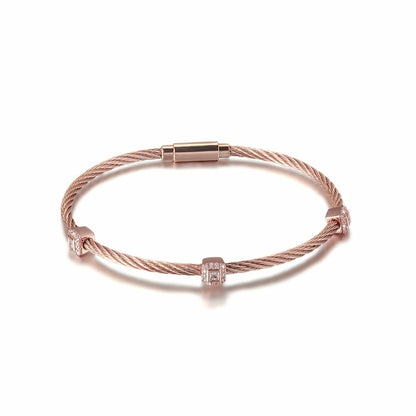Rose gold bracelet with diamond accents on a white background