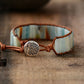 Bracelet with ceramic band and metal heart charm on a wooden surface