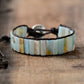 Beaded bracelet with leather strap on a wooden surface