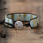 Bracelet with tree of life charm on a wooden surface