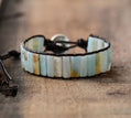 Bracelet with striped pattern on a wooden surface