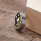 Two-tone ring with gold and silver finish on a wooden surface
