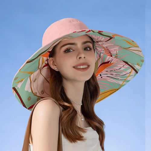 Woman wearing a colorful sun hat against a blue sky