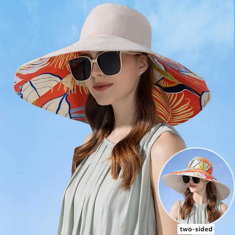 Woman wearing a two-sided sun hat with a colorful design against a blue sky.