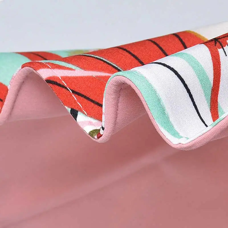 Close-up of a colorful fabric with a pattern on a pink background