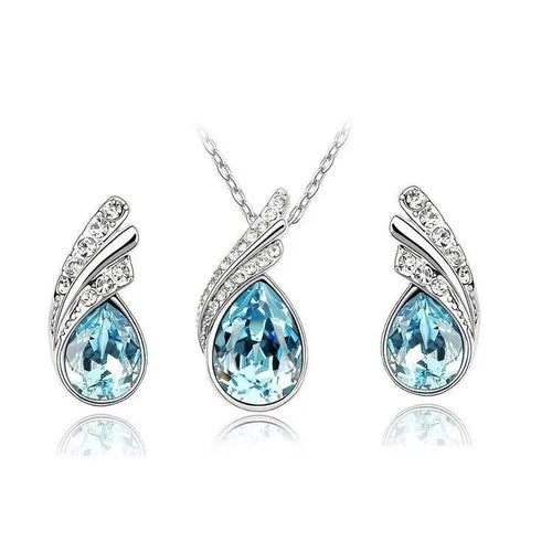 Jewelry set with teardrop-shaped blue stones on a white background