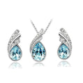 Jewelry set with teardrop-shaped blue stones on a white background