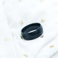 Black ring on a white surface with gold accents
