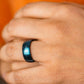 Close-up of a hand wearing a blue smart ring against an orange background