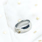 Silver ring on a white background with gold accents