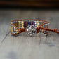 Bracelet with bead details and a decorative clasp on a wooden surface